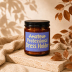 Amber jar with a black lid labeled "Amateur Professional Dress Holder Vowed".