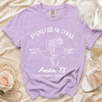 Purple t-shirt with "Reckless in Texas" and disco cowgirl design.