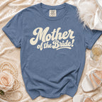 Blue t-shirt with "Mother of the Bride!" in cream retro font.