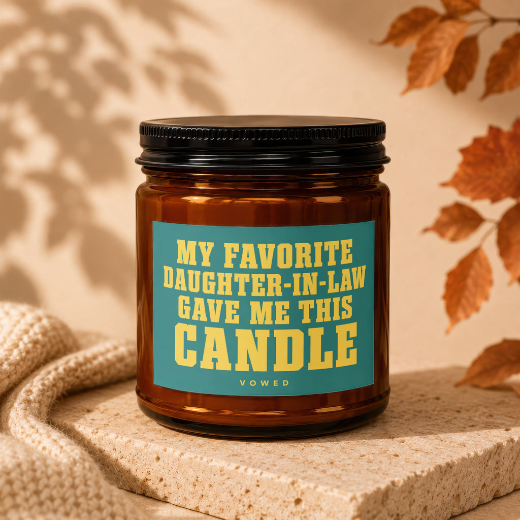 Amber glass candle with a teal label that says "MY FAVORITE DAUGHTER-IN-LAW GAVE ME THIS CANDLE".