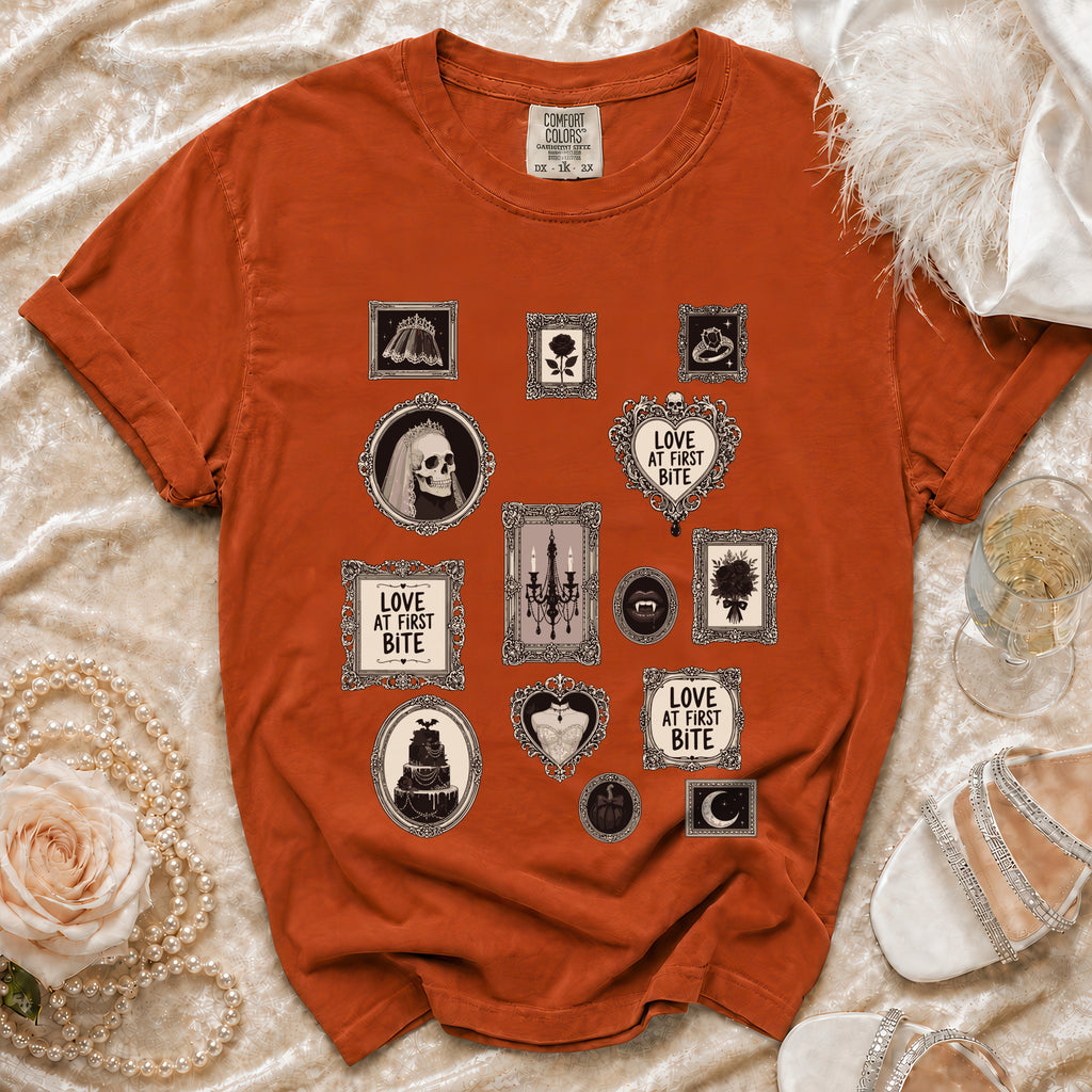 Orange t-shirt with framed gothic motifs including skulls, roses, and the text "Love at First Bite".