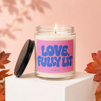 Glass candle with pink label reading "LOVE, FULLY LIT" and "VOWED".