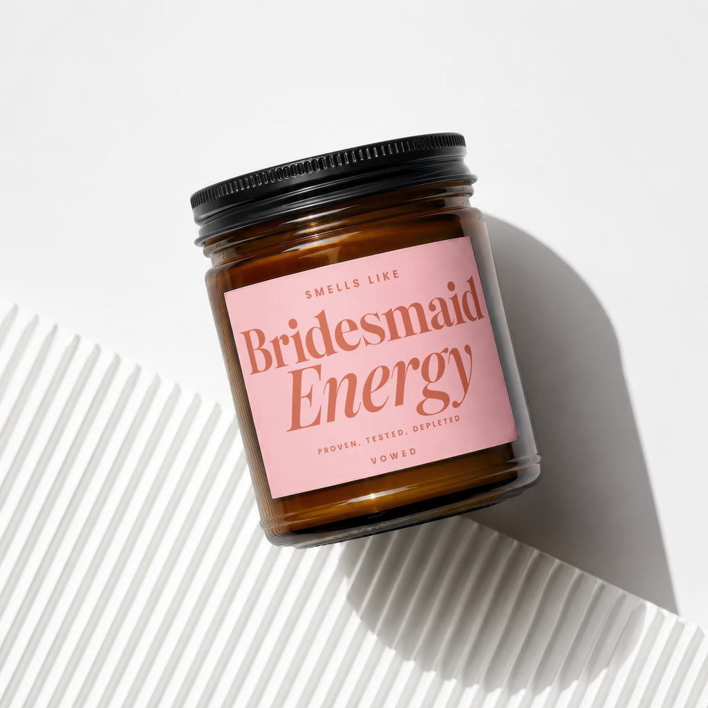 Candle labeled "Smells Like Bridesmaid Energy", "Proven, Tested, Depleted", "Vowed".