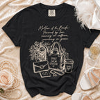 Black t-shirt with "Mother of the Bride" graphic featuring flowers, purse, and coffee cup.