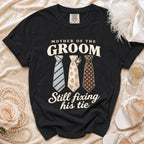Black Comfort Colors t-shirt with "Mother of the Groom Still Fixing His Tie" text and three ties.