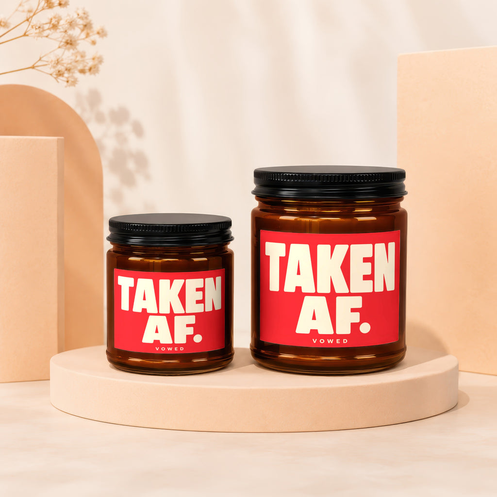 Two amber jars with black lids and red labels reading "TAKEN AF. VOWED".
