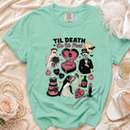Mint green t-shirt with "Til Death Do Us Part" design featuring skeletons, ghost bride, and wedding elements.