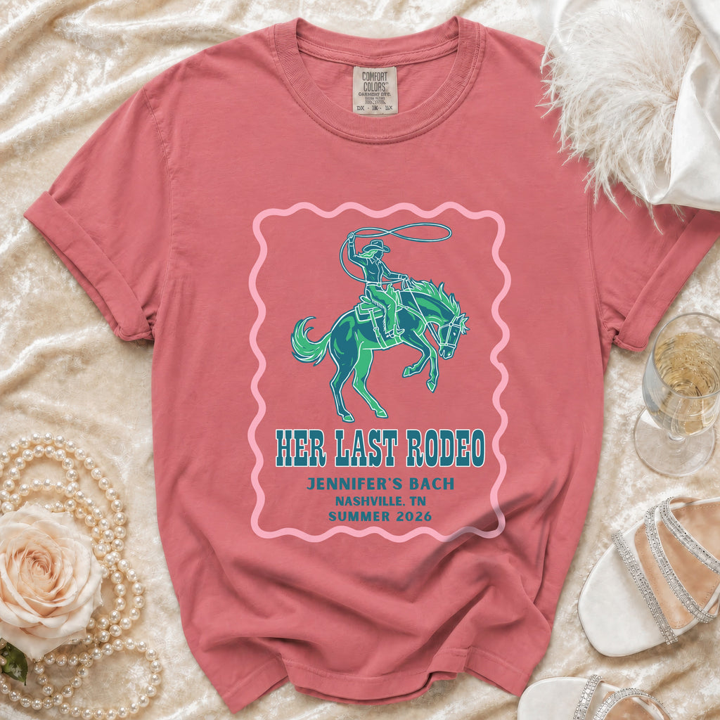 "Her Last Rodeo" text on pink frame over t-shirt with cowboy on bucking horse graphic.