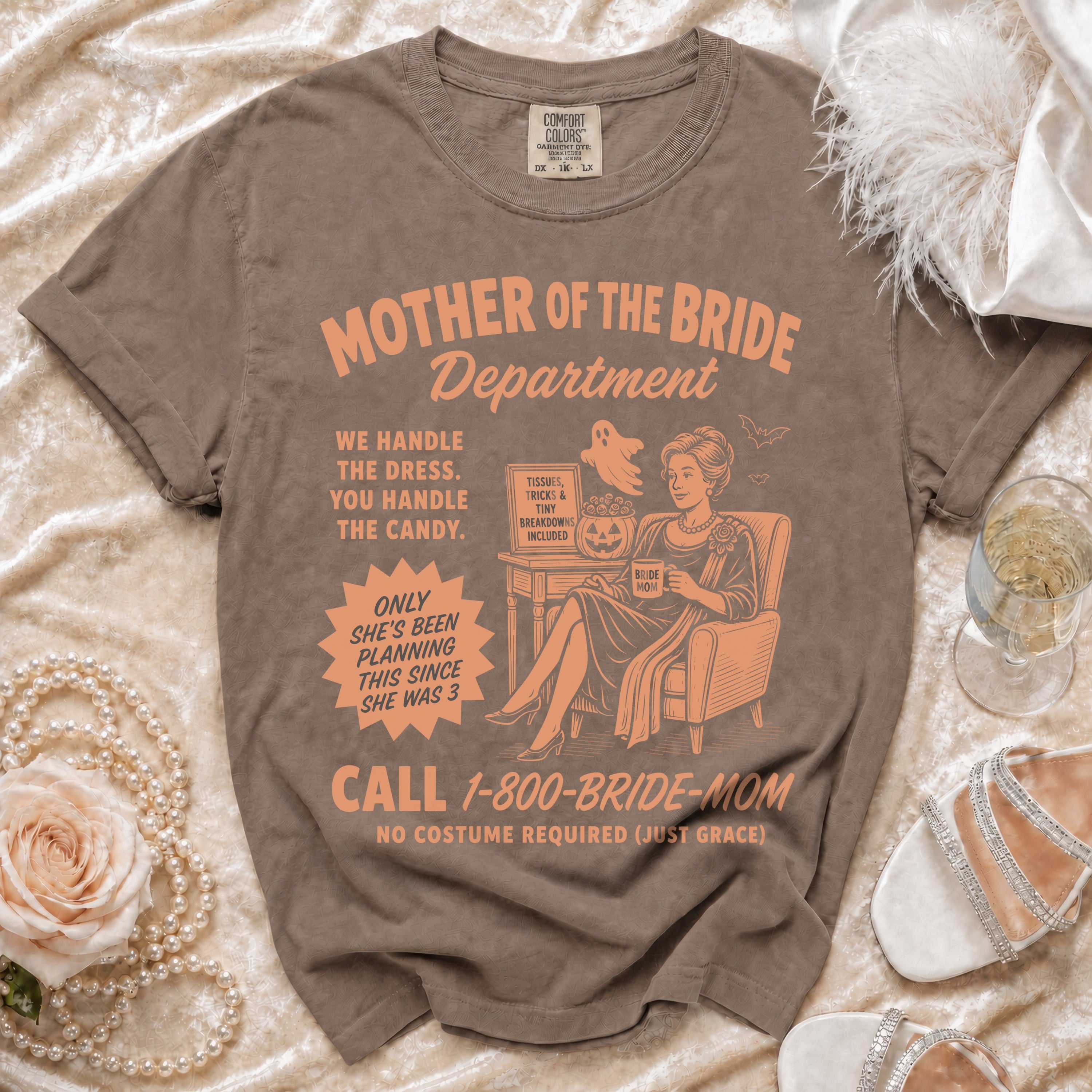 Brown t-shirt with "Mother of the Bride Department" text and illustration.