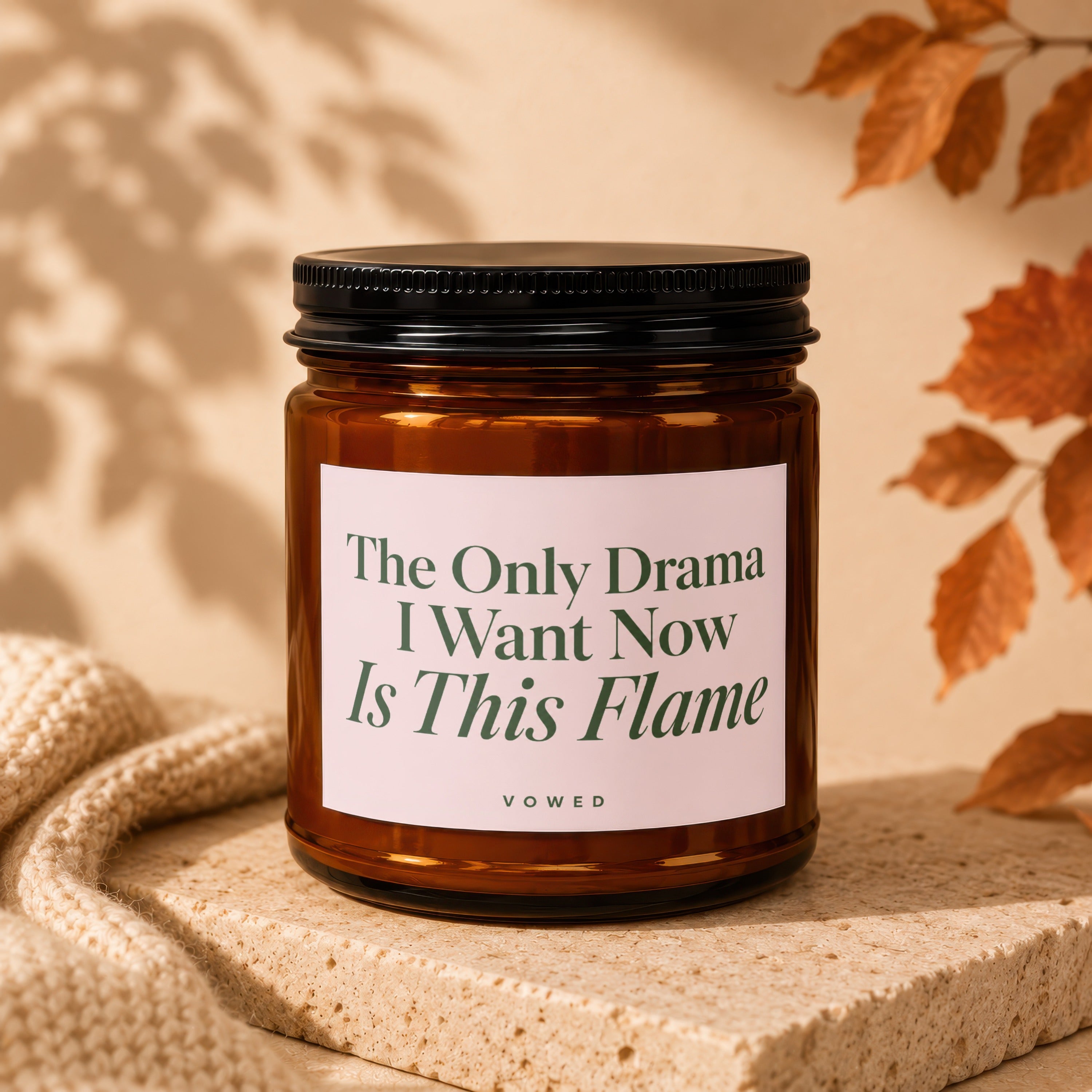 Brown glass candle with black lid and a label that reads "The Only Drama I Want Now Is This Flame".