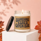 Candle with "Smells Like Someone Else's Open Bar" text and flickering flame.