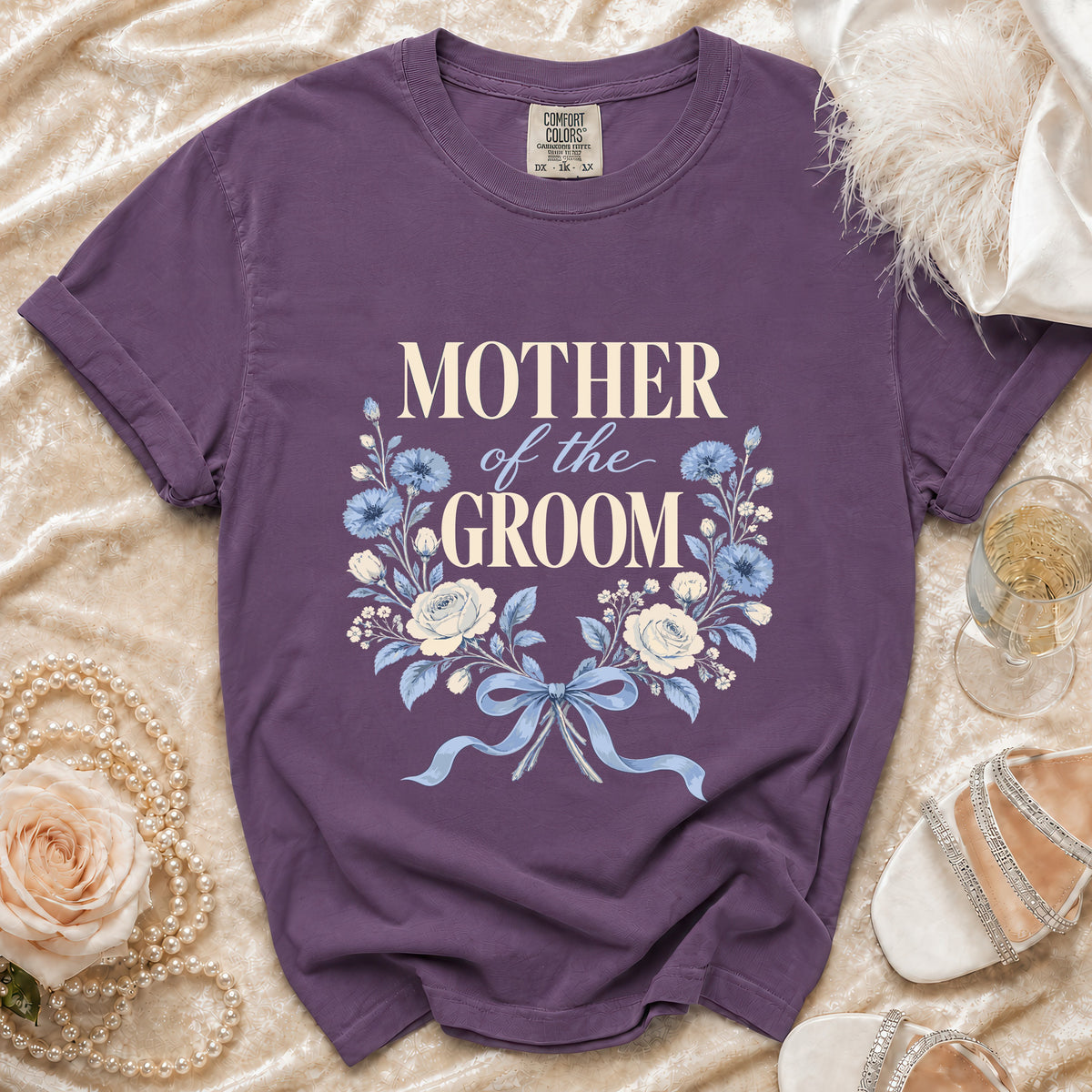 Purple t-shirt with "Mother of the Groom" text and floral design.