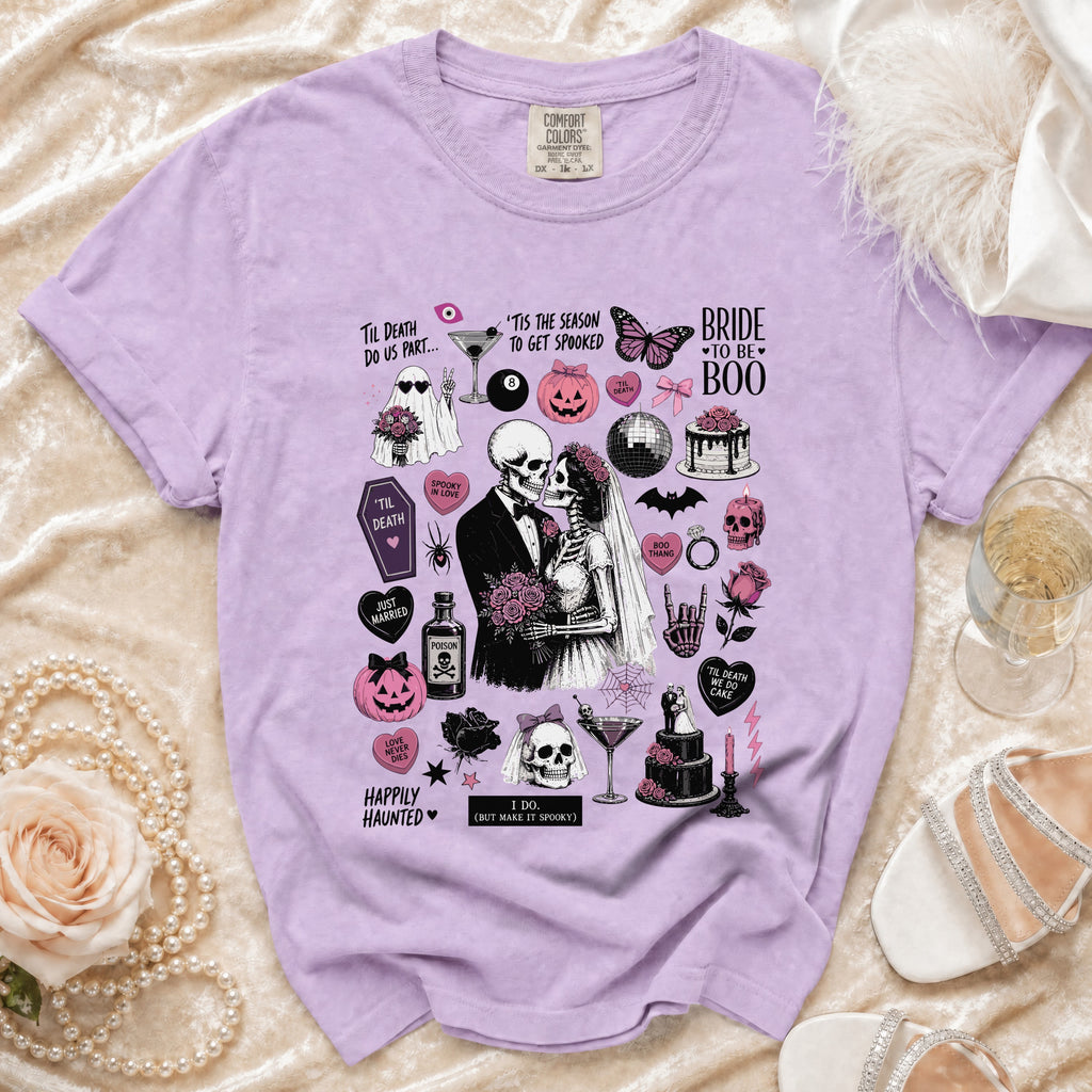 Purple Comfort Colors t-shirt with a spooky skeleton bride and groom graphic and wedding-themed Halloween icons.