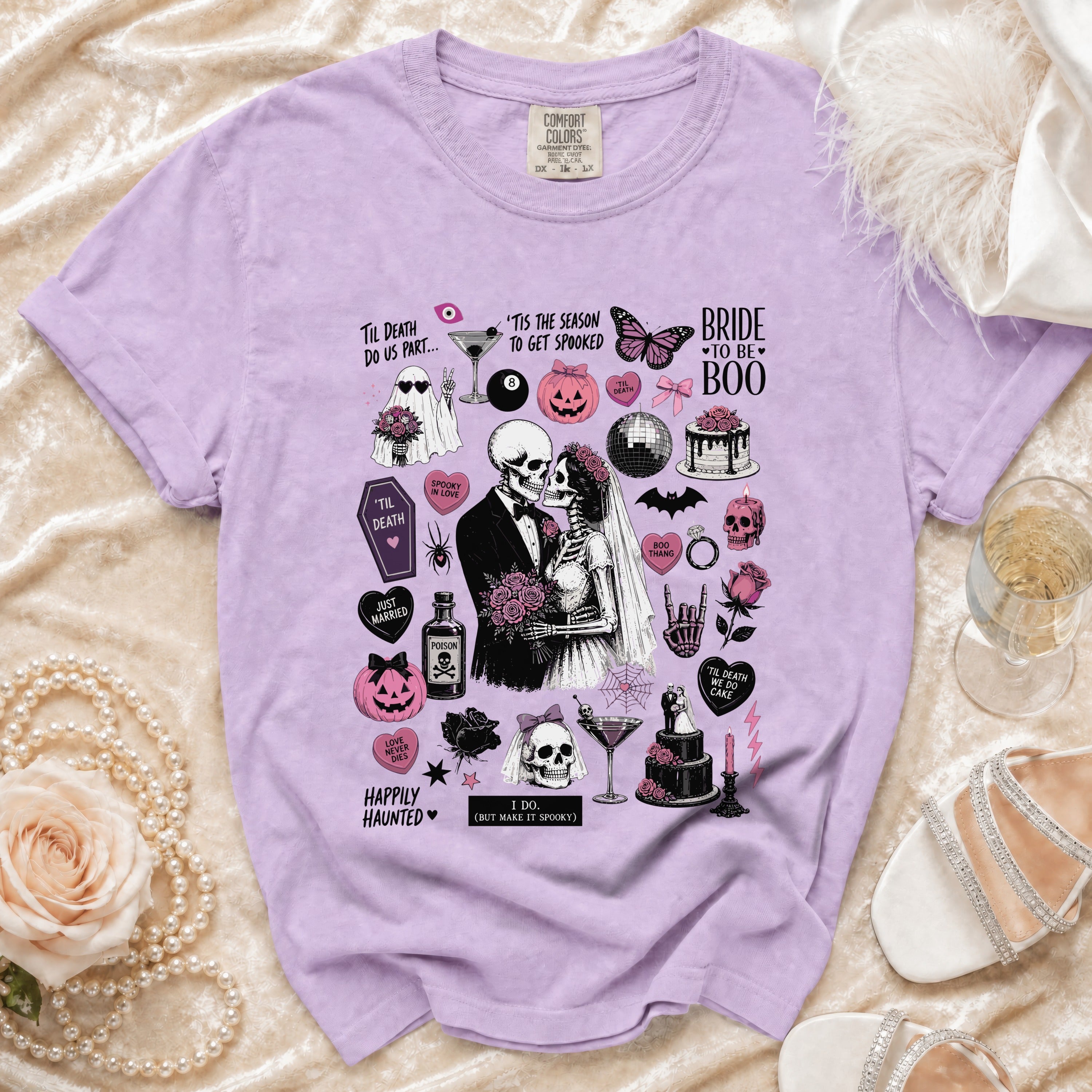 Purple Comfort Colors t-shirt with a spooky skeleton bride and groom graphic and wedding-themed Halloween icons.