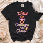 Black t-shirt with "I Run On Champagne And Chaos" graphic and a diamond ring.