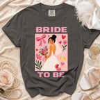Dark grey t-shirt with a pink graphic of a bride and "BRIDE TO BE" text.