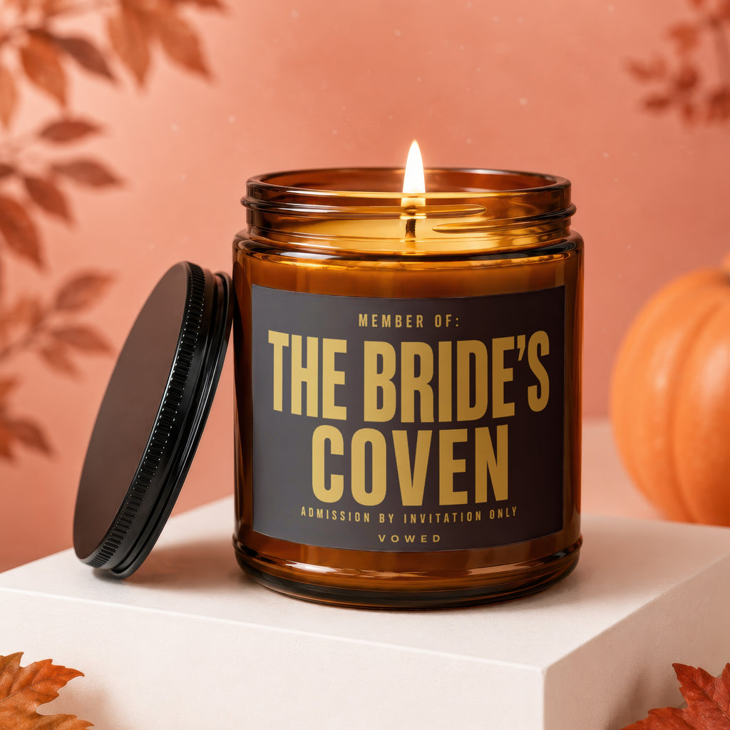 Amber candle with prominent label "THE BRIDE'S COVEN" with other text.