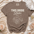 Brown t-shirt with "THIS BRIDE Bites" text and a skeleton hand holding a ring.