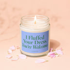 Jar candle with blue label reading "I Fluffed Your Dress. You're Welcome. Vowed."