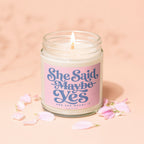 Candle with "She Said Maybe Yes And She Meant It" text on a pink label.