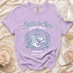 Purple Comfort Colors t-shirt with "Reckless in Texas Olivia's Bach" and cowboy boots graphic.