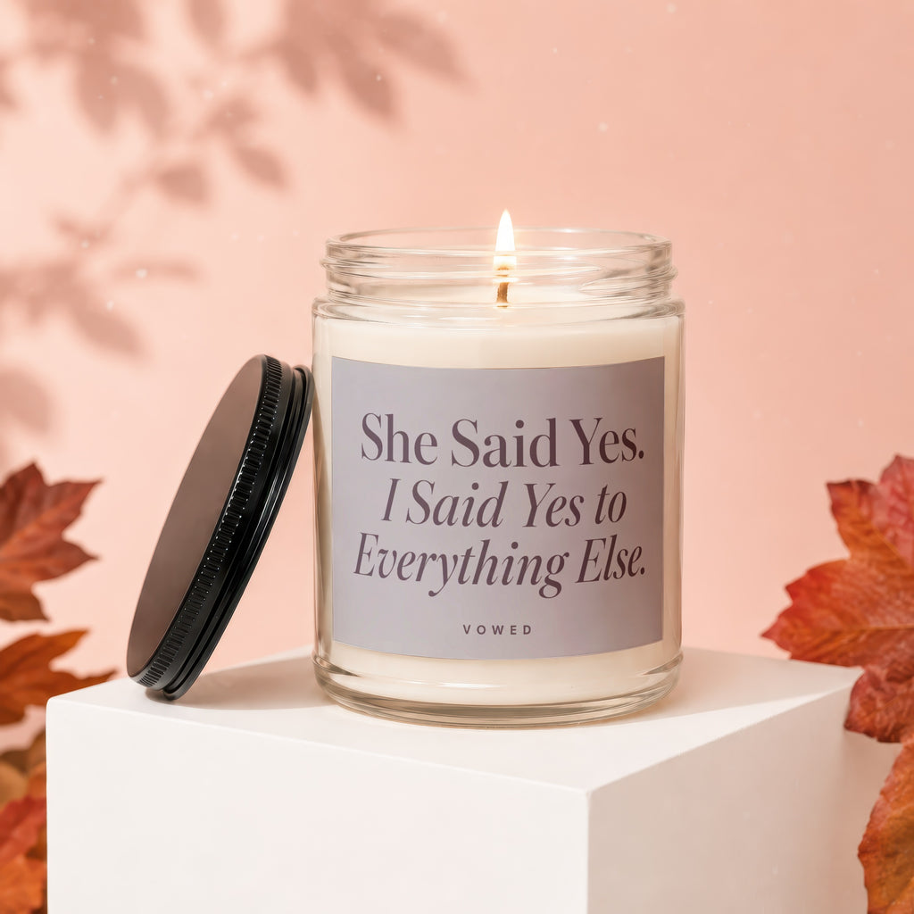 Glass candle with "She Said Yes. I Said Yes to Everything Else." text.