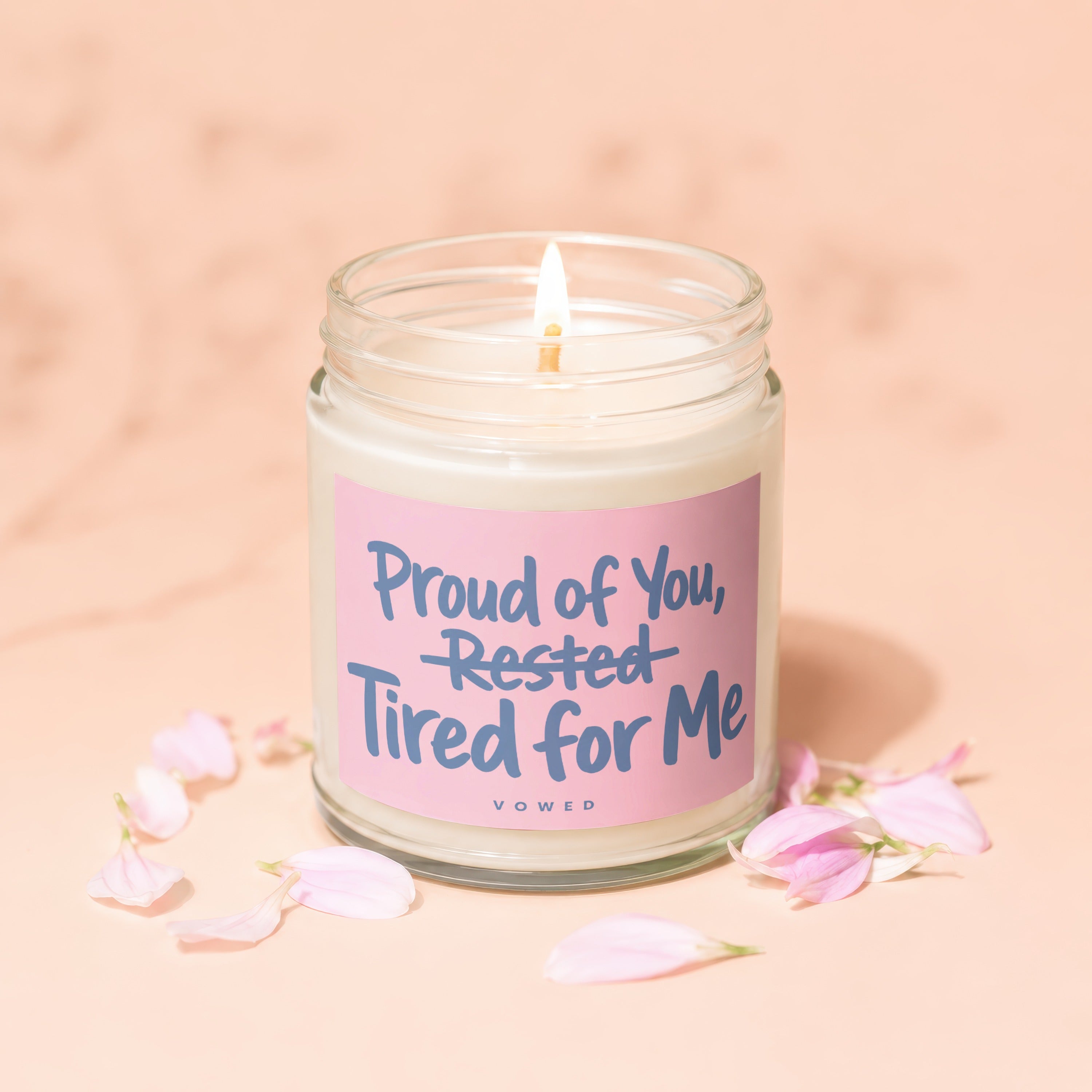 Jar candle with pink label reading "Proud of You, Rested, Tired for Me".