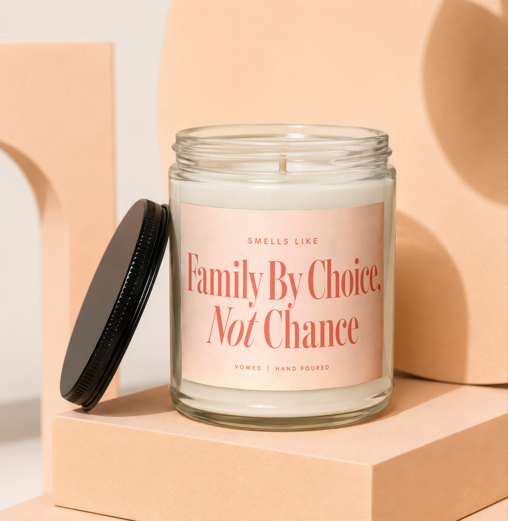 Glass candle with black lid reads "Family By Choice, Not Chance"