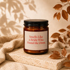 Amber candle with a black lid, labeled "Smells Like a Bride Who Found the Dress."