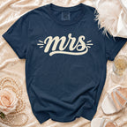 Navy Comfort Colors t-shirt with cream "mrs" text, on satin.