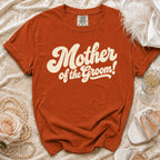 Orange t-shirt with "Mother of the Groom!" graphic, pearls, and shoes.