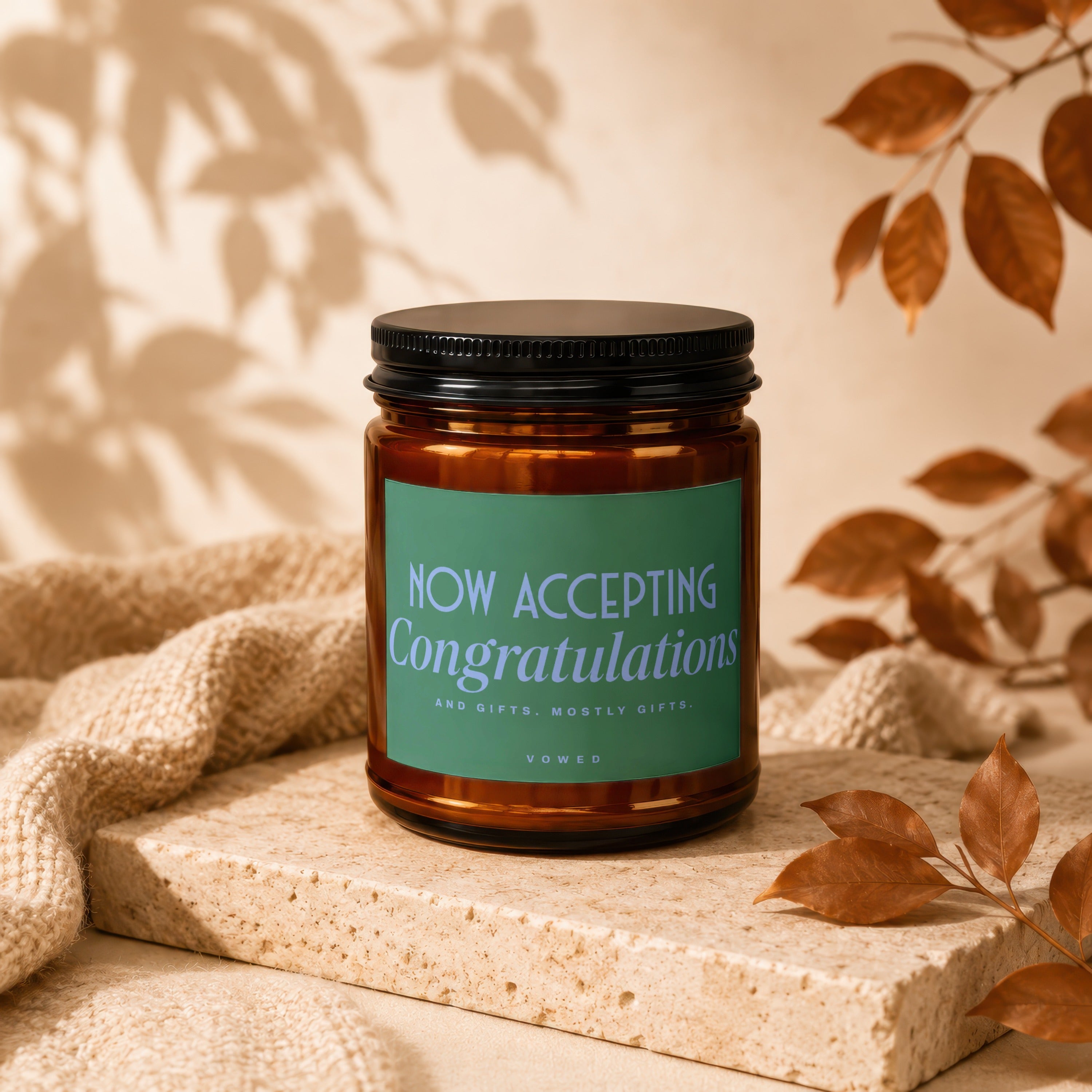 Brown glass candle with green label saying "NOW ACCEPTING Congratulations".