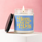 Scented candle with lit wick, blue label reading "Here for the IDs" and "VOWED".