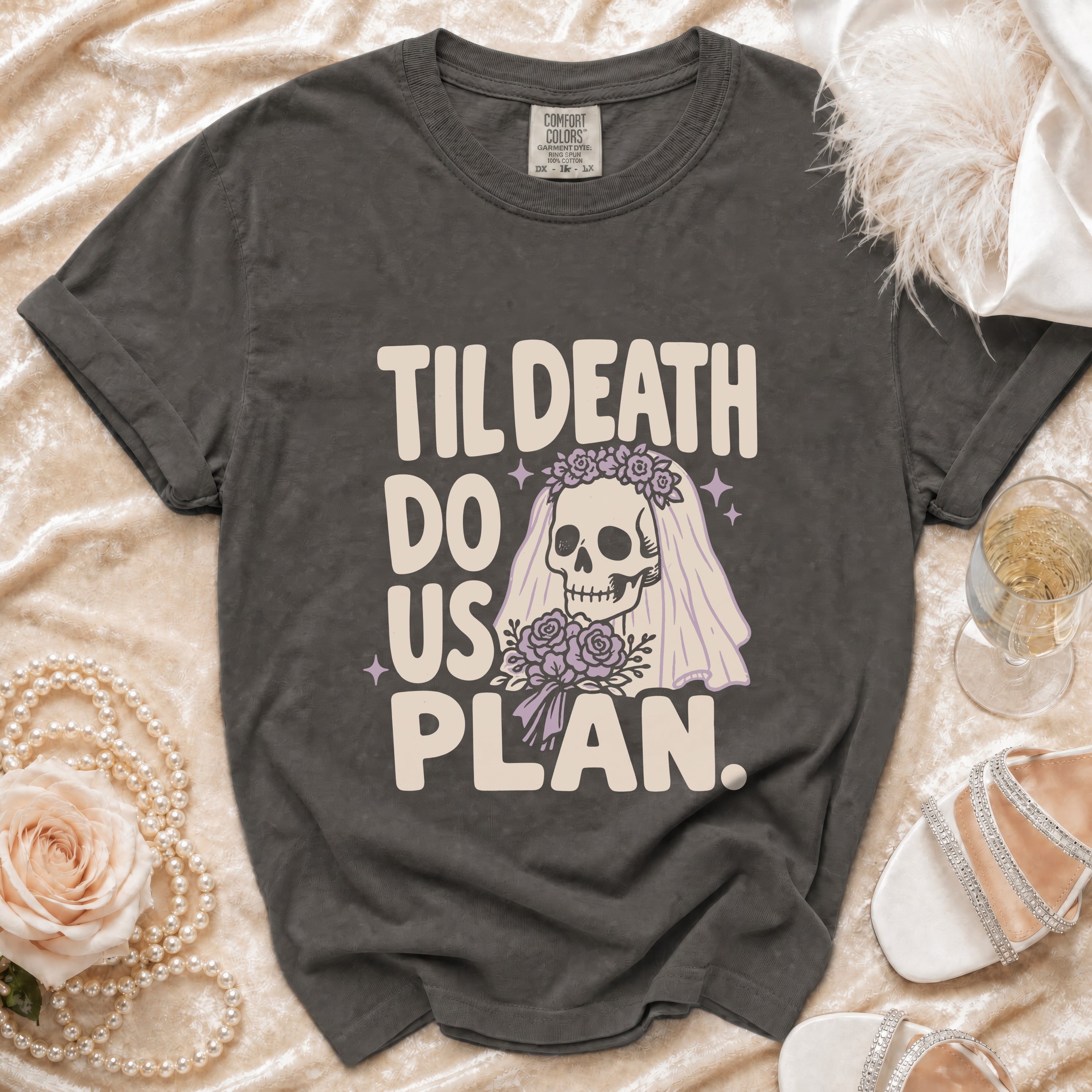 T-shirt with text "Til Death Do Us Plan" and skull bride graphic.