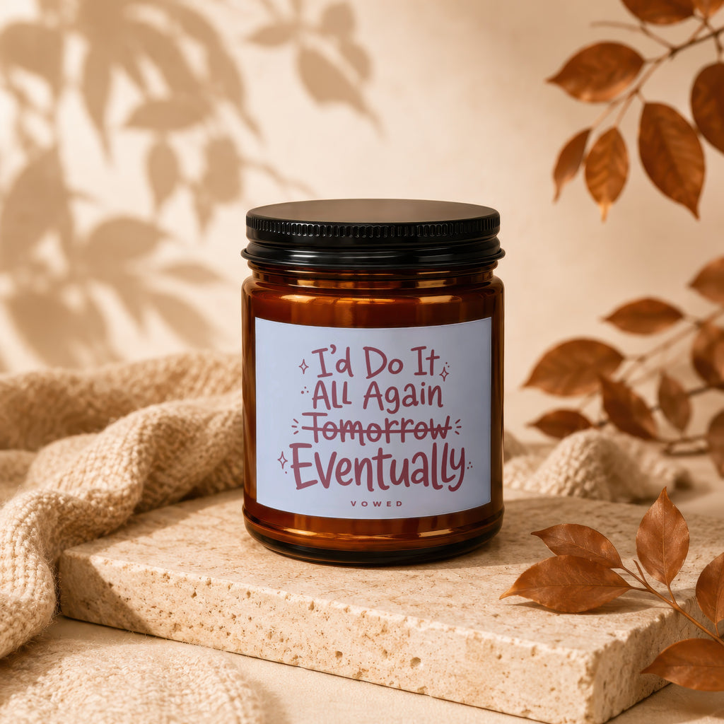 Amber candle with black lid and label reading "I'd Do It All Again Tomorrow Eventually VOWED".