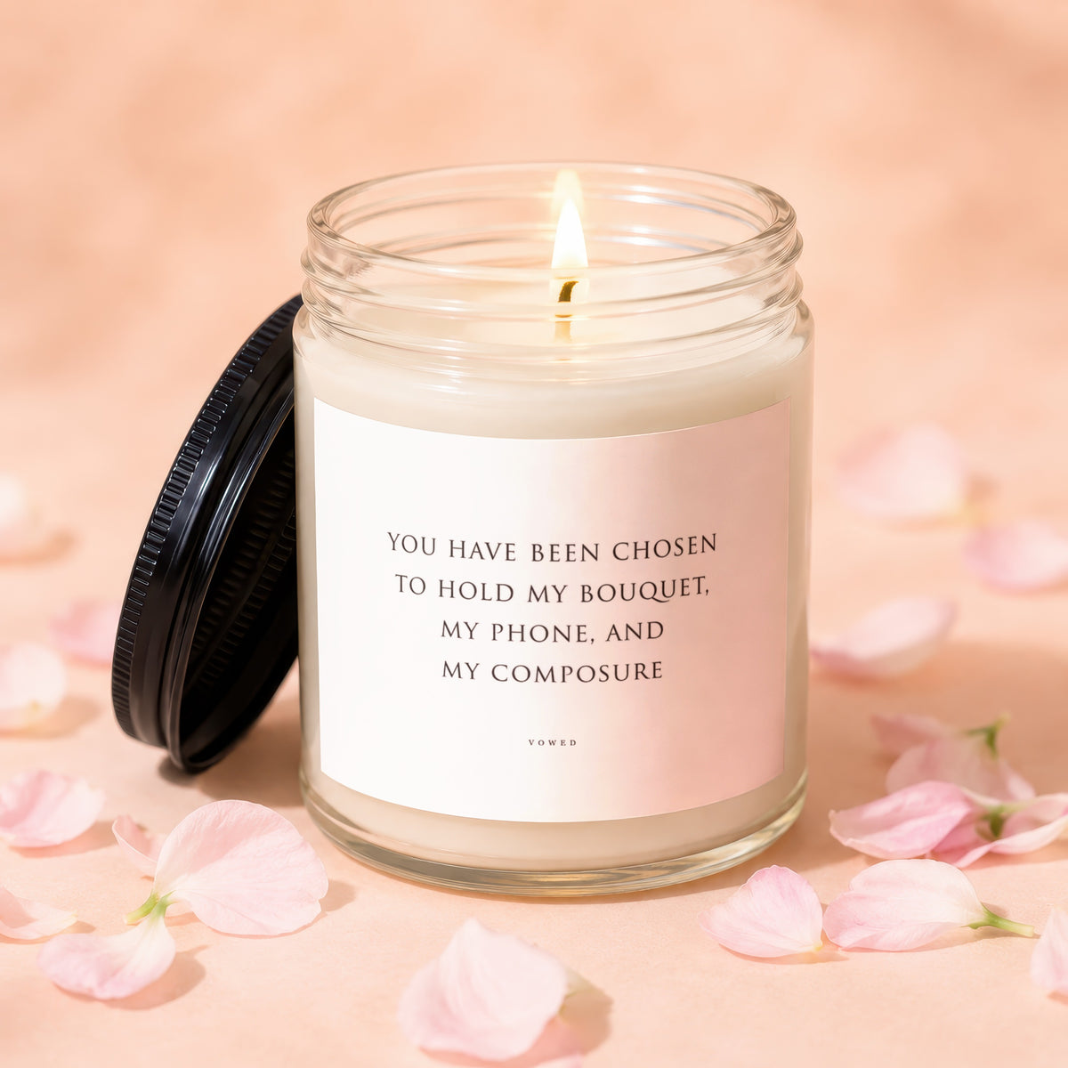 Lit candle with text: "You have been chosen to hold my bouquet, my phone, and my composure."