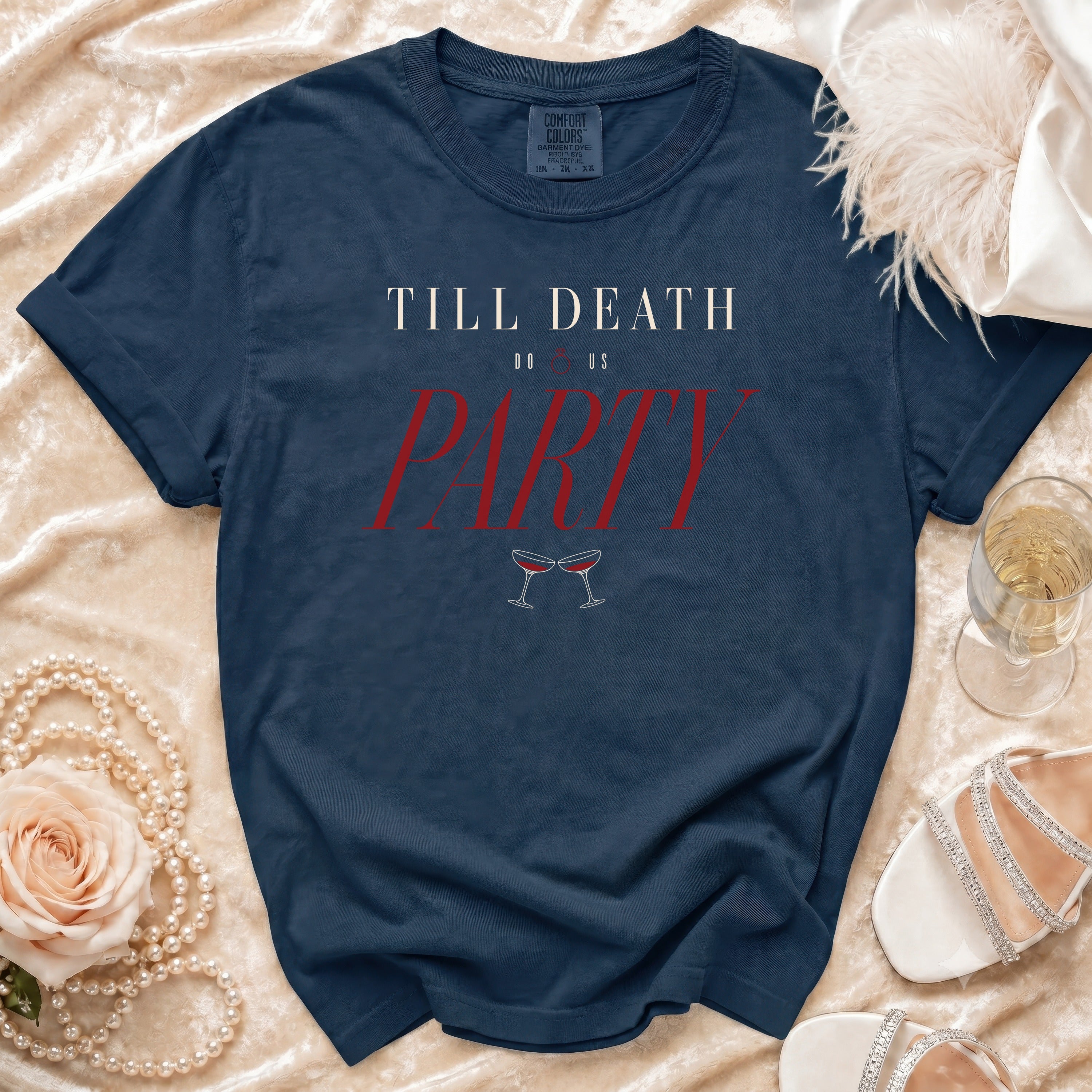 Navy t-shirt with "Till Death Do Us Party" text and champagne glasses graphic.