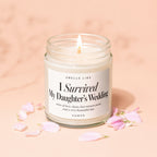 Candle titled "I Survived My Daughter's Wedding" with scent notes on a peach background.