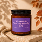 Amber jar candle with purple label reading "Welcome to Your Pre-Wedding Era."