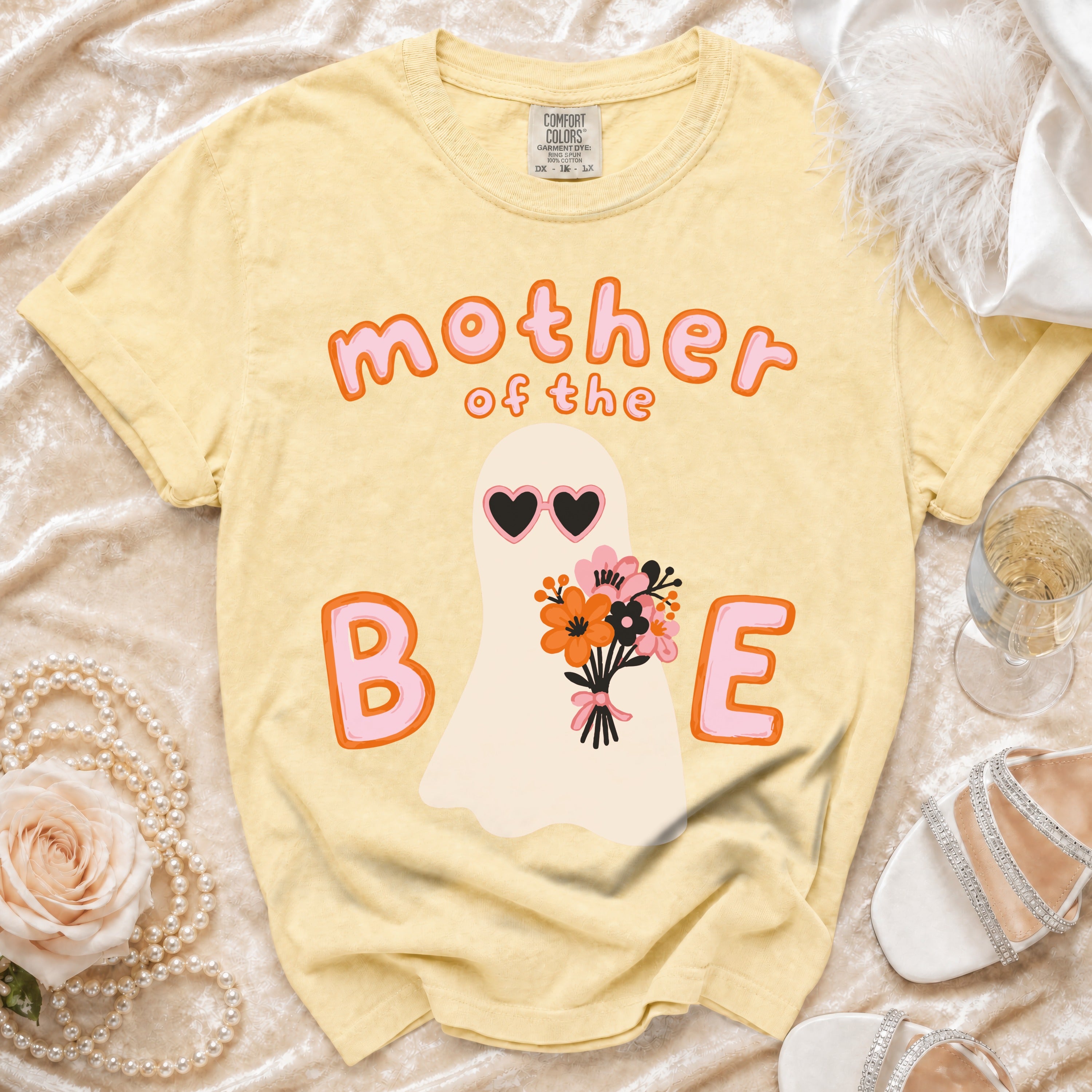 Yellow t-shirt with ghost graphic saying "mother of the B E".