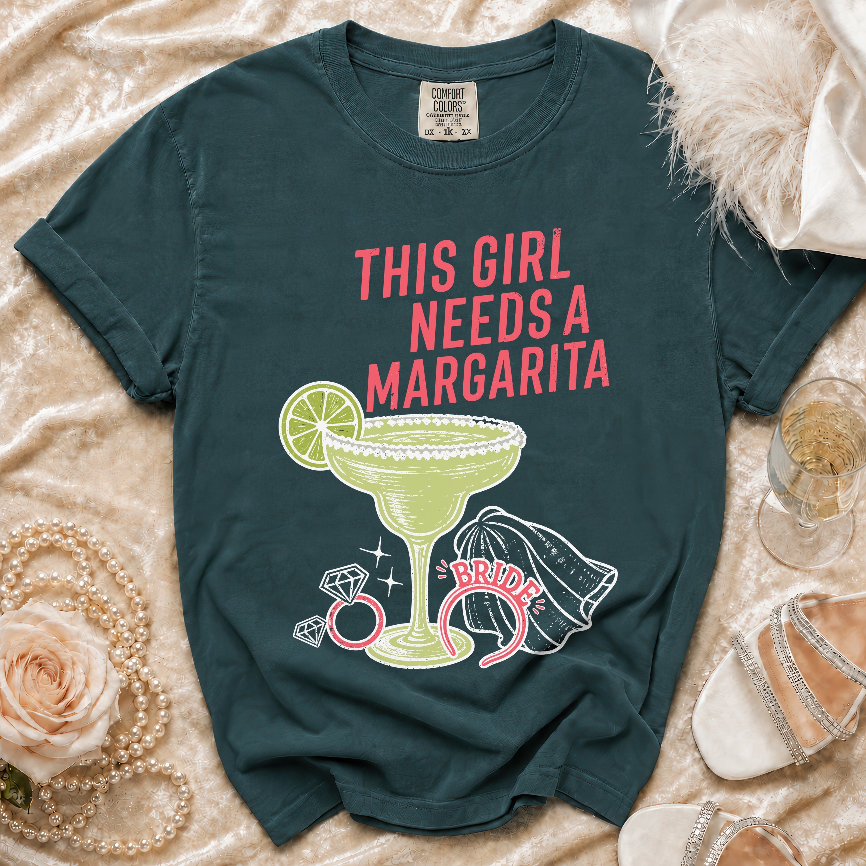 Dark teal t-shirt with "This Girl Needs A Margarita" text and margarita graphic.