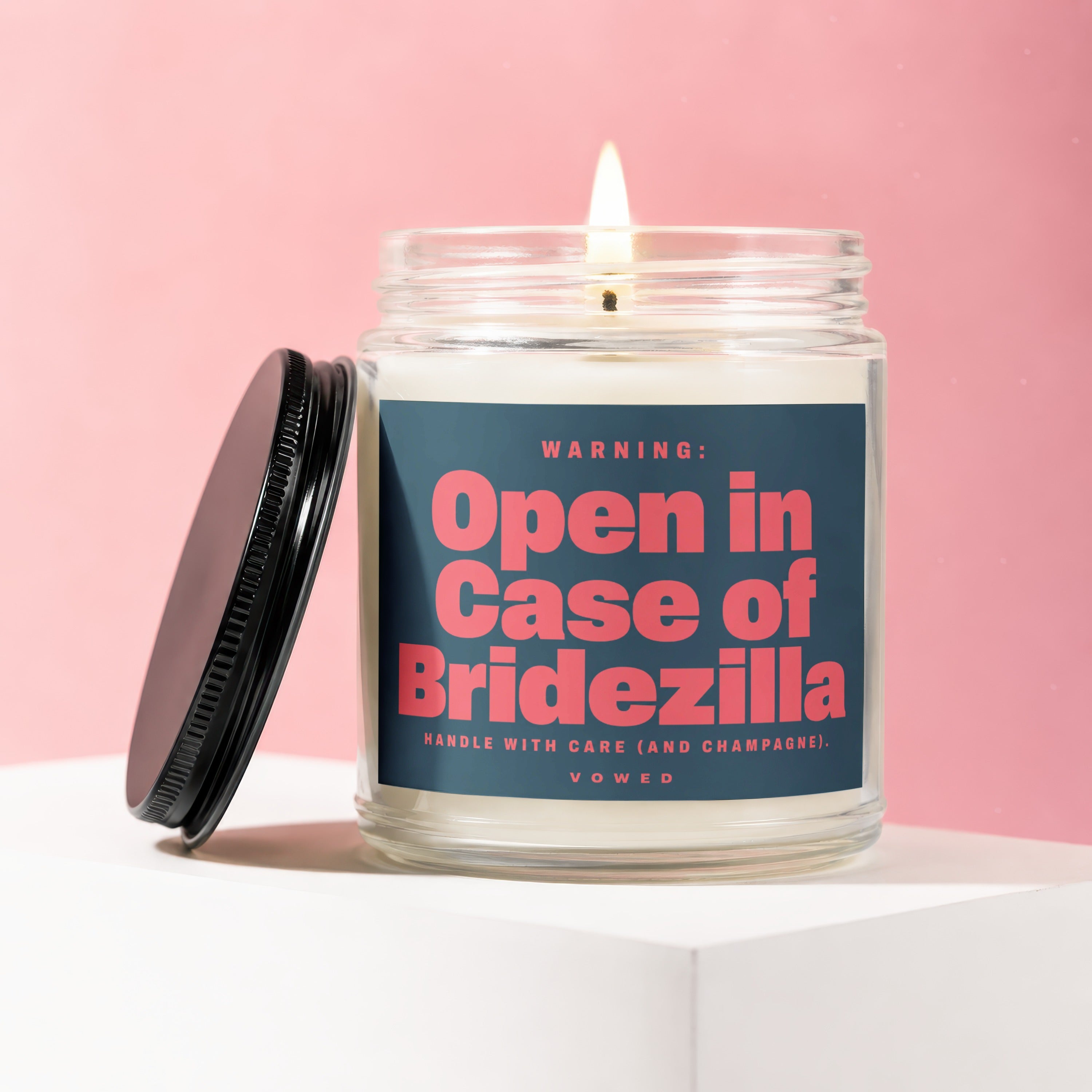 Glass candle with pink text "Open in Case of Bridezilla" on dark blue label.