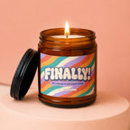 Lit candle in amber jar with label: "FINALLY! WE CALLED IT ON DATE THREE VOWED".