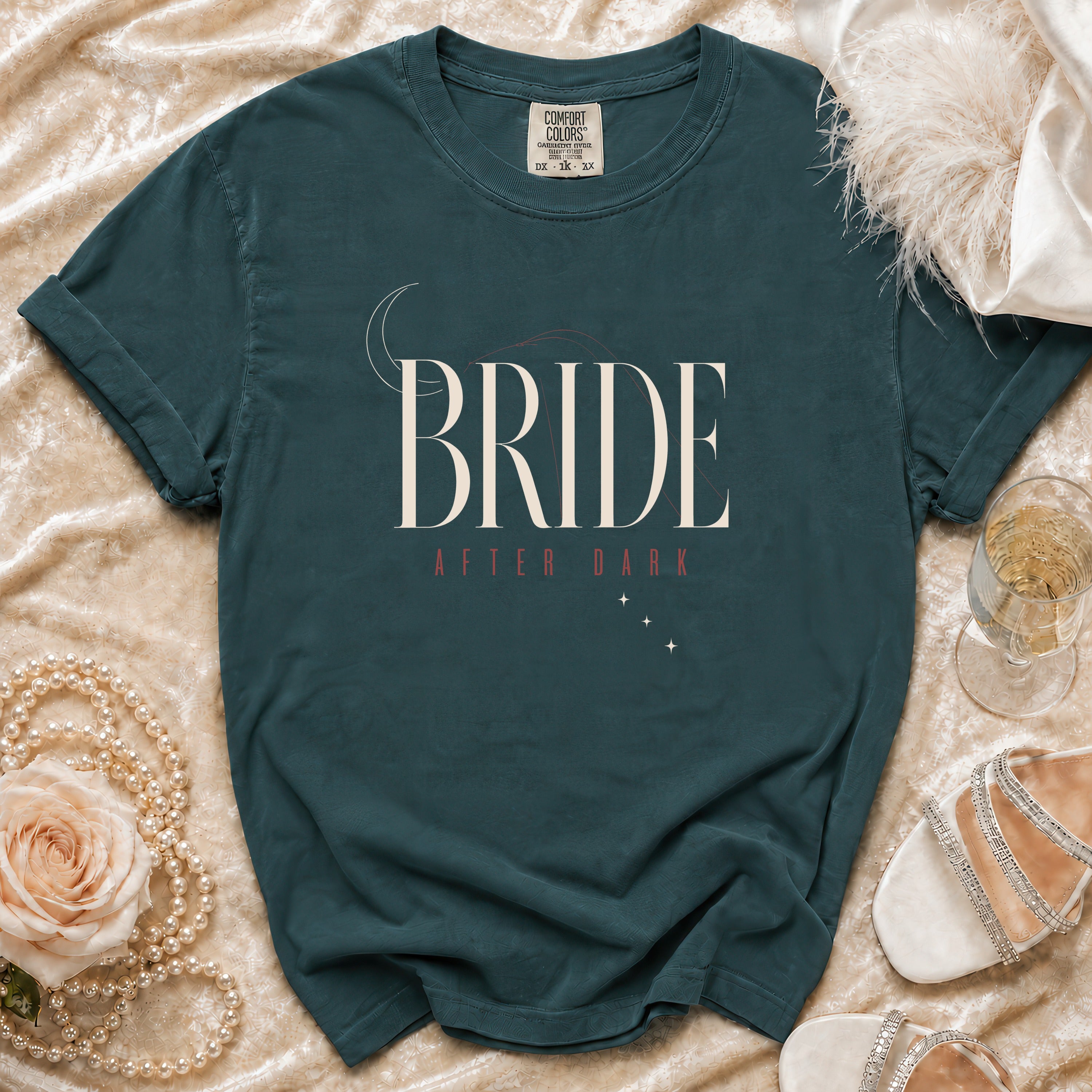 Teal t-shirt with "BRIDE AFTER DARK" text and celestial design.