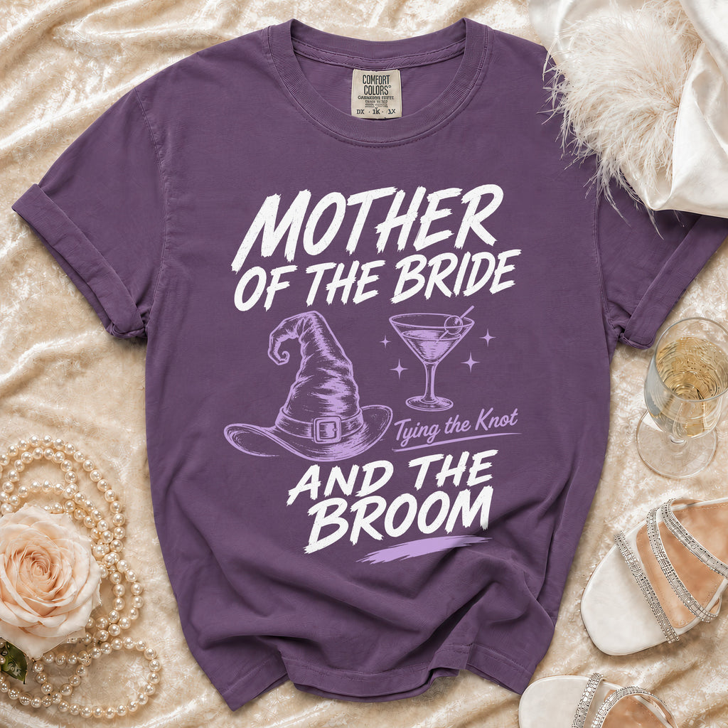 Purple Comfort Colors t-shirt with "Mother of the Bride, Tying the Knot, And the Broom" text and graphics.