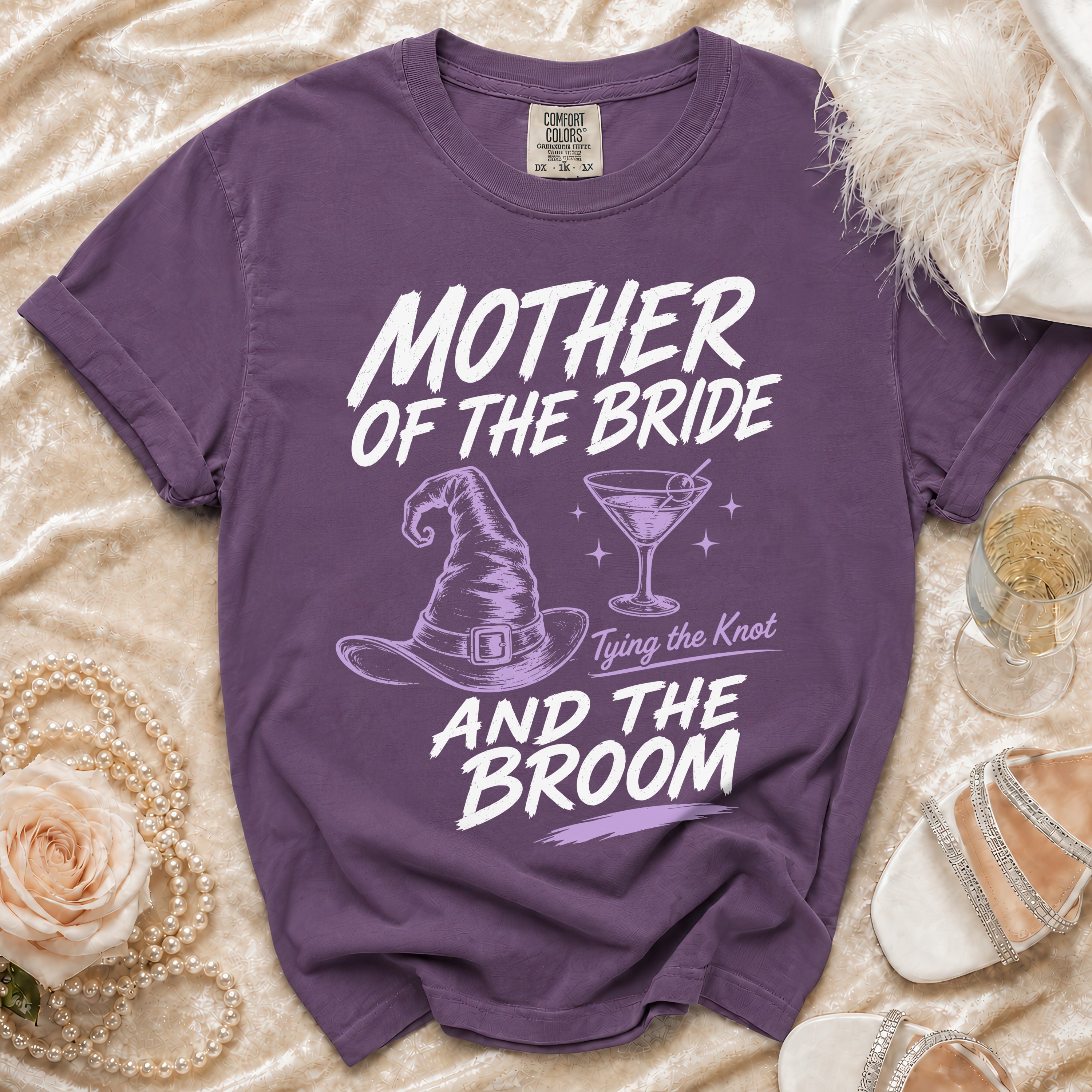 Purple Comfort Colors t-shirt with "Mother of the Bride, Tying the Knot, And the Broom" text and graphics.