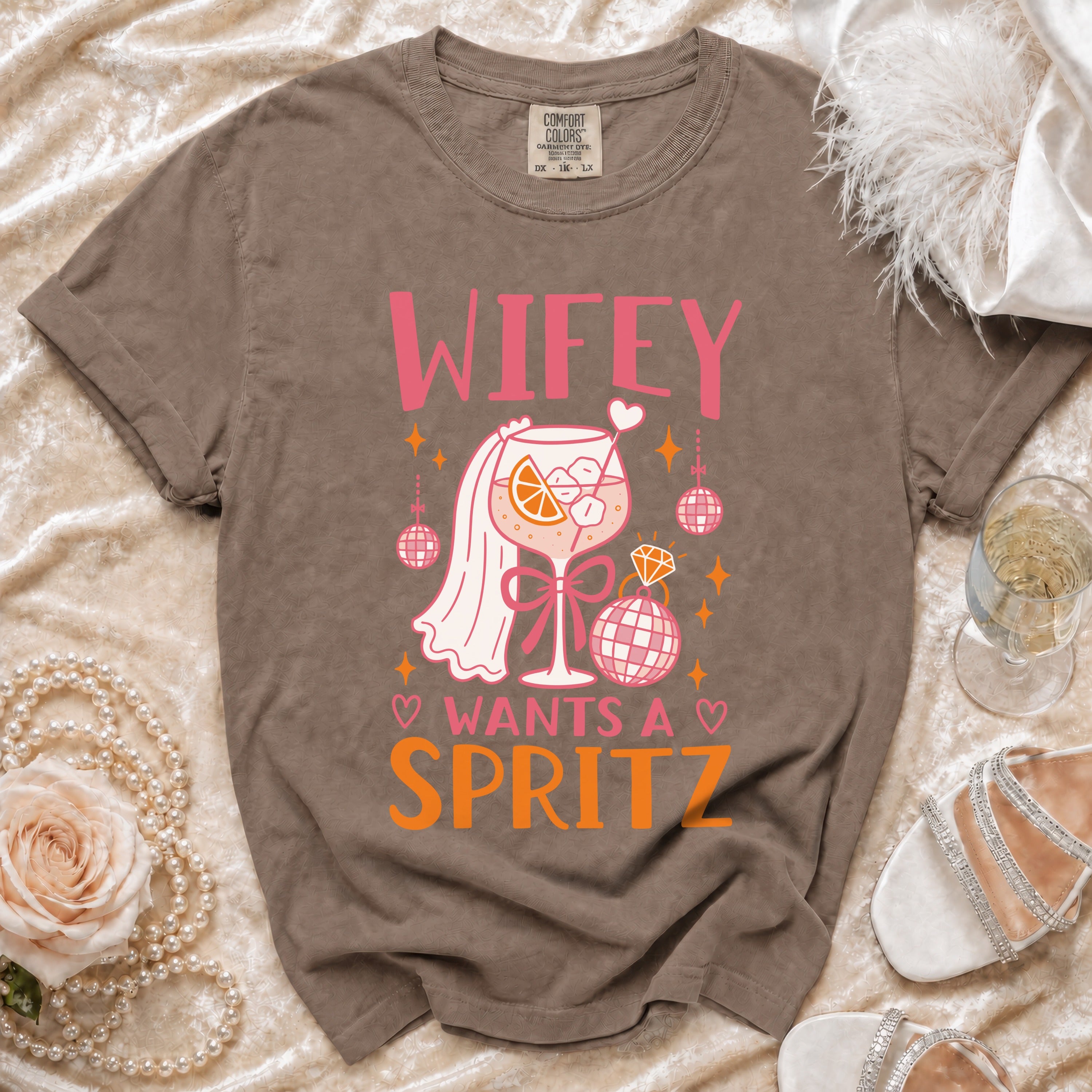 Brown t-shirt with "Wifey Wants A Spritz" graphic featuring a cocktail and disco balls.