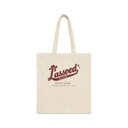 A beige canvas tote bag features brown text reading "Lassoed for life Bach Crew Fort Worth, 2027".