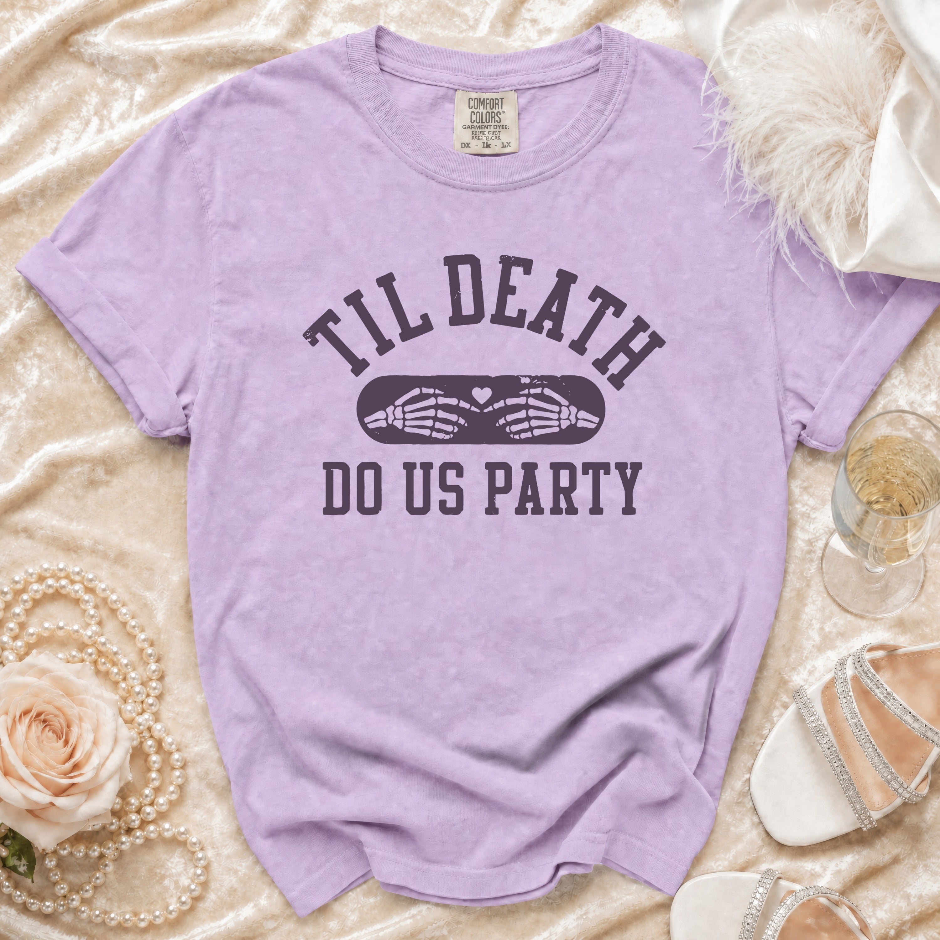 Lavender t-shirt with "Til Death Do Us Party" text and skeleton hands.