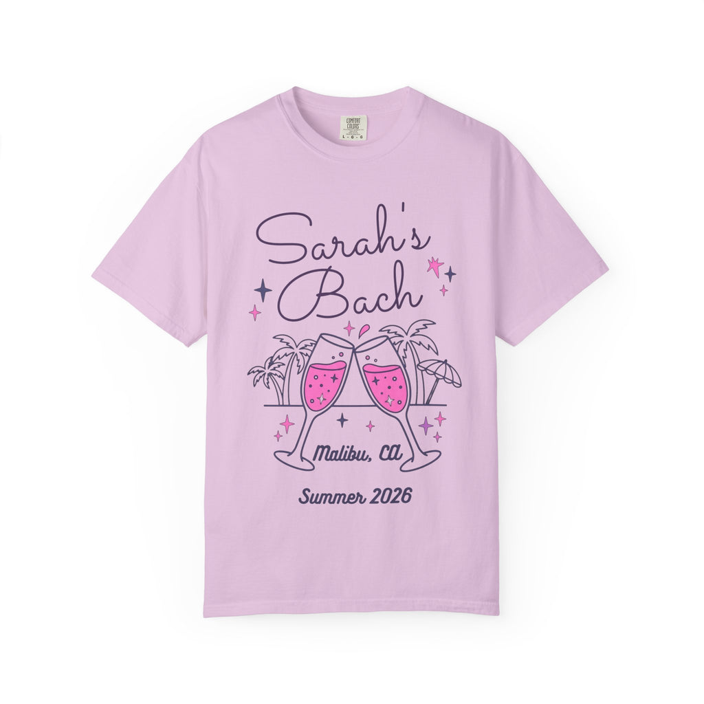 Sarah's Bach Malibu, CA 2026 t-shirt with clinking champagne glasses.